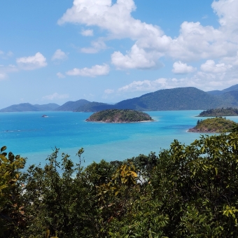Lone Island View, Shute Harbour, with a green island amongst bright blue ocean