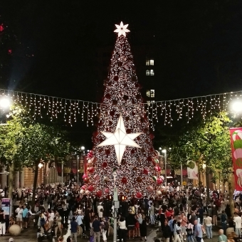 Martin Place Christmas, with a five-storey Christmas tree centre-frame surrounded by people